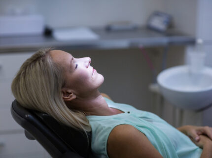 Woman relaxing on dentist chair in dental clinic